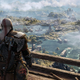 Kratos stands on a crow's nest and looks out over a sunny waterlogged valley in God of War Ragnarok.